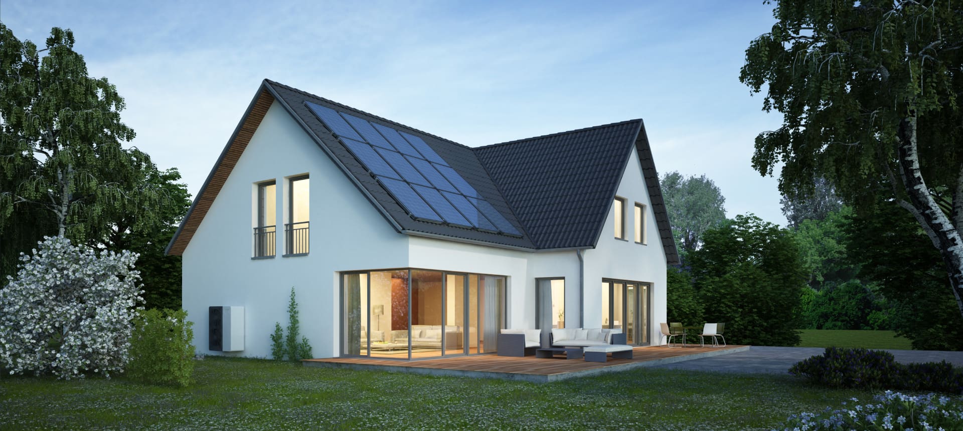 Modern house with solar panels on the roof under a clear sky.